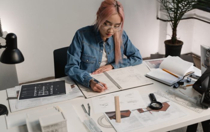 Woman with pink hair working at desk